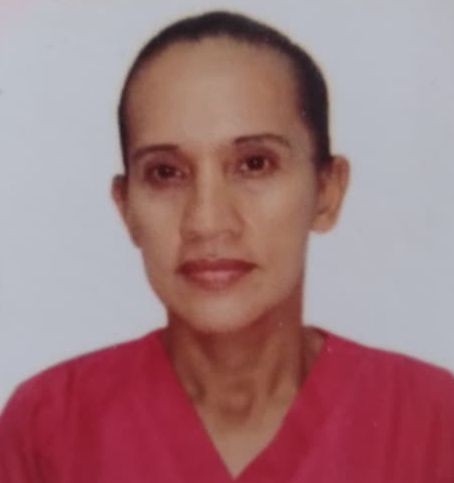 Person wearing a red shirt against a plain background.