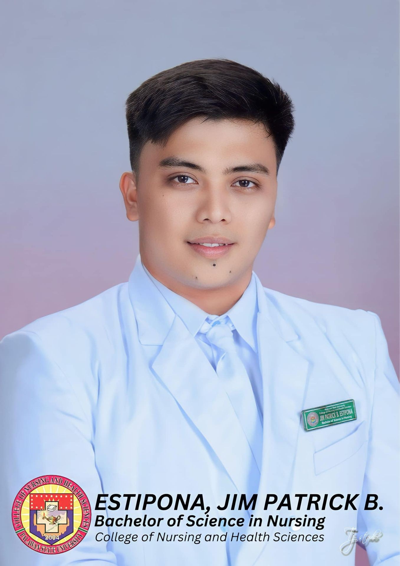 Man in a white suit with a nursing badge poses against a neutral background.